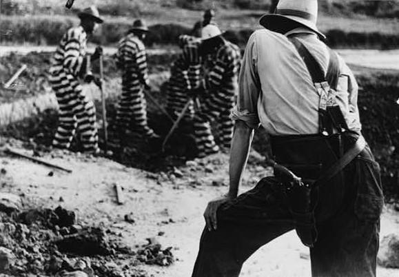 Convicts and a guard at a lease convict camp