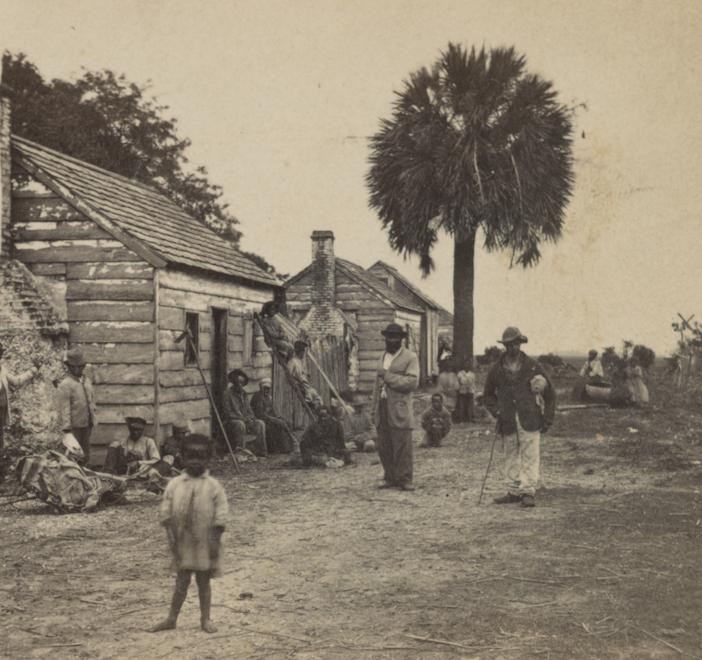 A picture of enslaved people, including children, outside of slave quarters. In addition to showing the terrible living circumstances and ongoing surveillance that enslaved populations had to deal with, this picture highlights the existence of family life under slavery.